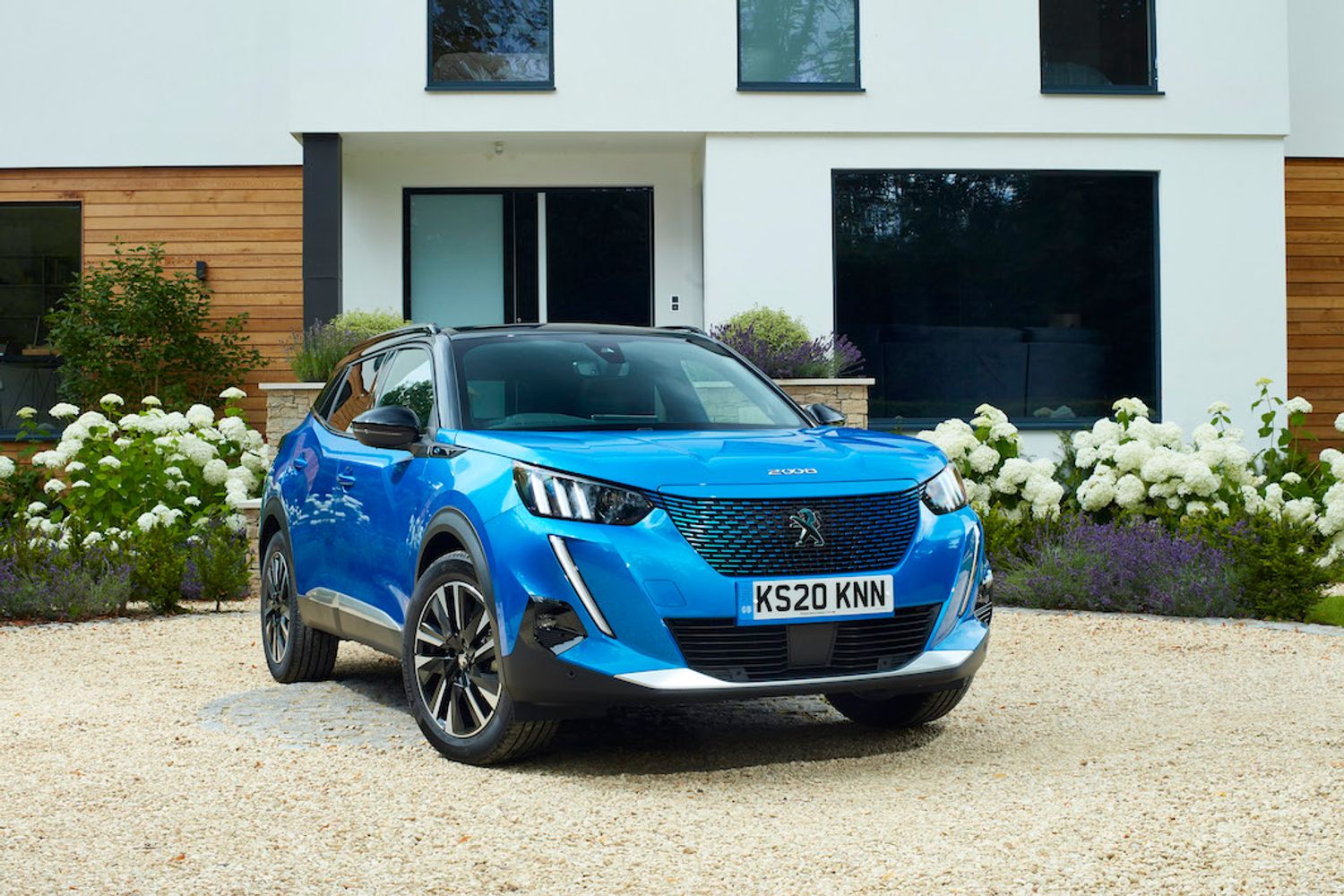 Peugeot E2008 electric car parked in driveway